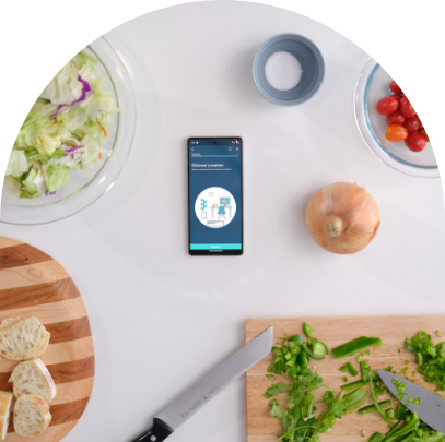 Mobile device displaying app from kitchen counter